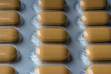 Medical tablets in blisters lie on the surface