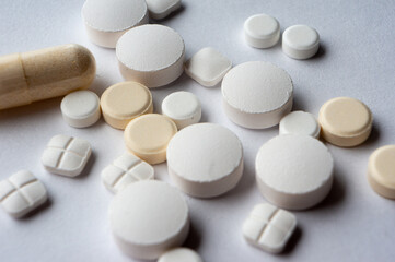 Medical tablets are scattered on the surface