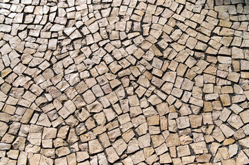Detailed arrangement of cobblestones creates a beautiful texture in a city environment under bright...