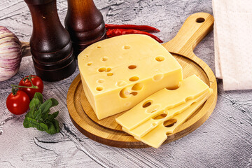 Maasdam cheese piece with slices
