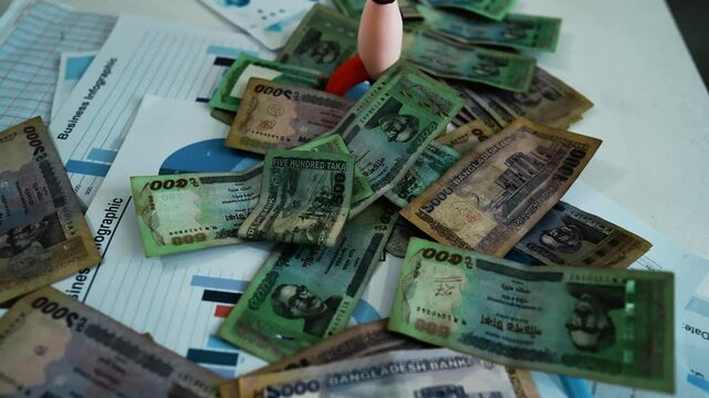 Bangladeshi Banknotes on Business Charts, A pile of Thai baht banknotes scattered over business charts and documents