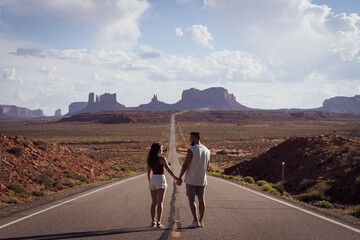 Young couple sightseeing on a trip along the west coast of the United States with the scenery of...