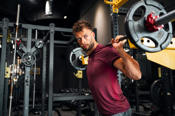 Man Lifting Barbell in Modern Gym Environment