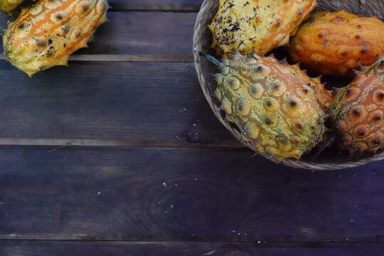 kiwano harvest in a wicker basket on a wooden base. kiwano ready to eat.