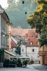 Obraz premium Ljubljana, Slovenia - August 15, 2024: Charming and beautiful city center of Ljubljana at dawn, with soft morning light and peaceful atmosphere