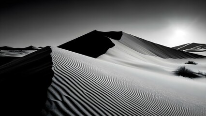 Black and white photograph of sand dunes with sharp peaks and textured ridges, illuminated by sunlight. Concept Black and White Photography, Sand Dunes, Textured Ridges, Sharp Peaks