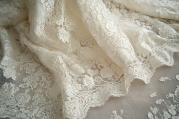 Obraz premium Elegant ivory lace fabric, delicate floral pattern, soft texture, luxurious material, perfect for bridal or fashion design.