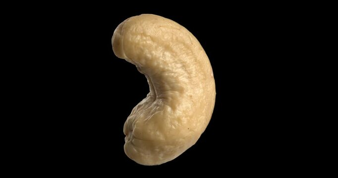 Cashew nut rotating on black background.