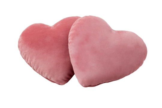 Pair of pink heart-shaped cushions on black background, cut out