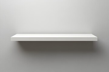 Empty white floating shelf against a neutral background