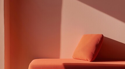 Corner of a room with a pink wall on the left side and a red sofa on the right side. the sofa has a modern design with a curved backrest and armrests.