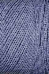 A close-up texture shot of blue yarn with diagonal stripes