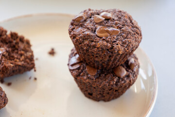  chocolate banana muffins on light background