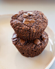  chocolate banana muffins on light background