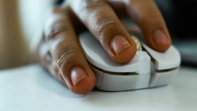 Close-Up of Hand Using White Computer Mouse, Close-up of a hand using a white computer mouse on a desk