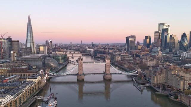 London, UK, aerial time lapse of the Thames river, tower bridge and the city skyline just before sunrise, calm morning city life