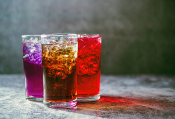 A lot of Soft drinks in colorful and flavorful glasses on the table,Glasses with sweet drinks with ice cubesv