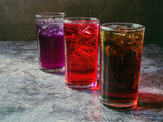 A lot of Soft drinks in colorful and flavorful glasses on the table,Glasses with sweet drinks with ice cubesv