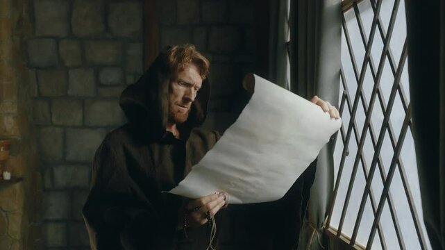 Medieval monk reading obsolete historical parchments and holy manuscripts