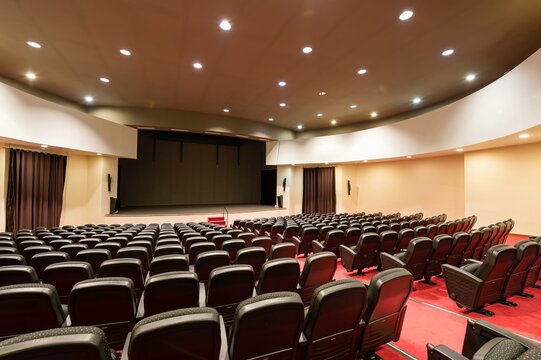 Spacious empty convention center with rows of seats and bright lights