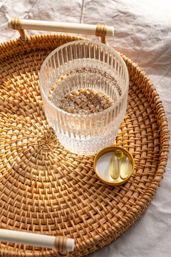 Omega 3 and vitamin D3 supplements on a rattan tray