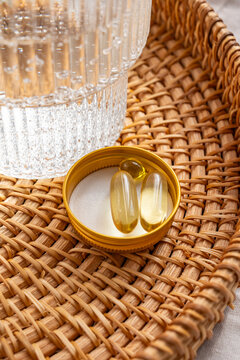 Omega 3 and Vitamin D3 supplements on a woven tray