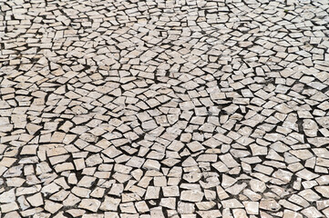 Intricate mosaic tiles arranged in a captivating pattern on a walkway, showcasing intricate craftsmanship.