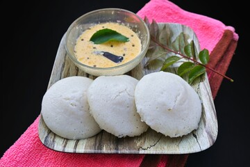 Idli, idly with coconut chutney. Most popular South Indian traditional healthy breakfast, made by steaming rice batter 