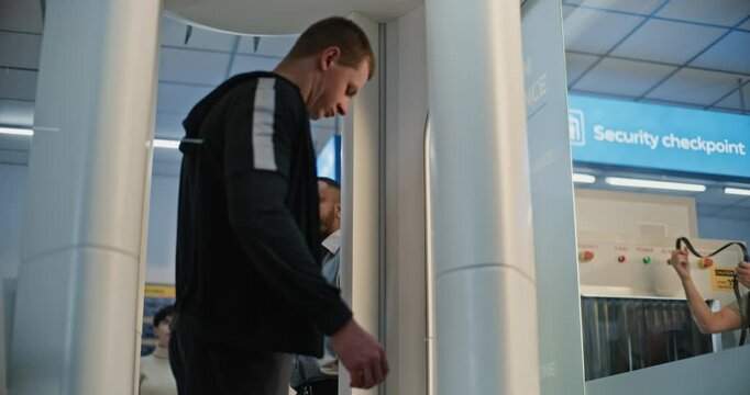 Security Checkpoint in Airport Terminal: Man with Prosthesis Leg and Adult Woman Passing Through Metal Detector Scanning Gates for Boarding Flight. Diverse Tourists During TSA Screening Procedures.