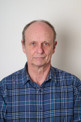 Obraz premium Senior man with a cotton shirt against white wall