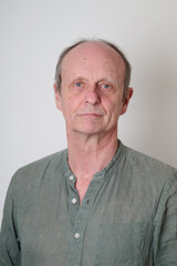 Obraz premium Senior man with a cotton shirt against white wall