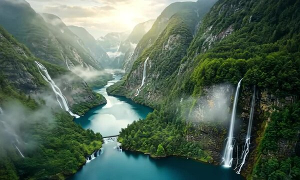 Aerial view of a river flowing through a valley with waterfalls and green mountains around it