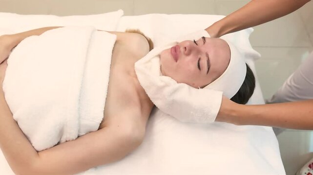 hot damp towel presses against the face. skilled professional performs precise injections using advanced techniques. Ideal for beauty clinics, wellness centers, and medical aesthetic content. 
