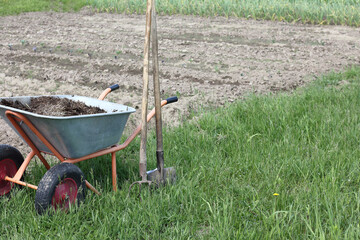 fertilizers in a wheelbarrow near the garden. nutrients to improve fertility