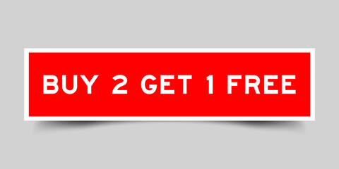 Red color square shape sticker label with word buy 2 get 1 free on gray background