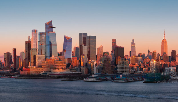 Fototapeta Aerial view of New York City skyline with Hudson River Park and Manhattan skyscrapers at sunset. Midtown high-rises, Hudson Yards and Chelsea Piers