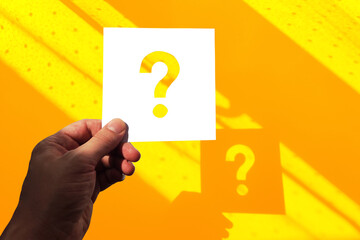 Question mark design. Hand holding note paper with question mark.