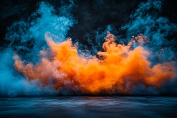 Fototapeta premium Vibrant smoke clouds in orange and blue create dramatic atmosphere in a dark setting during nighttime