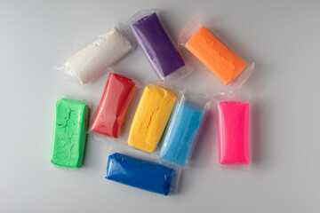 Colorful clay play sticks. Dough plasticine in bright colors.