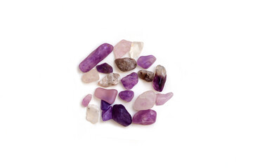 Top view of amethyst purple tumble stones on white background