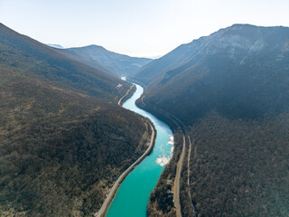 Soča River valley in Slovenia view from above. Asphalt road along the river. Winding river with turquoise water in a canyon in winter season © TatiG