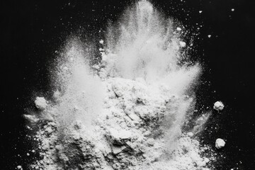 White powder explosion creates a dynamic texture on a dark background in a creative artistic setting