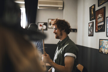 Man playing pool with friends in vintage bar