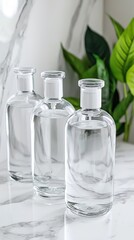Elegant marble surface showcasing three glass bottles with white pump tops, creating a striking minimalist aesthetic design