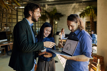 Young group of designers talking about the project in the office