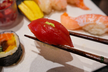 Tuna Nigiri Held by Chopsticks