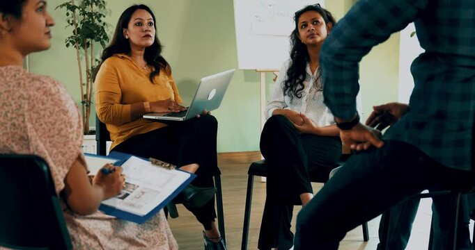 Indian Asian group in a business meeting, discussing mental health and support in a diverse office setting. Team communication, collaboration, and wellness in a professional conference room
