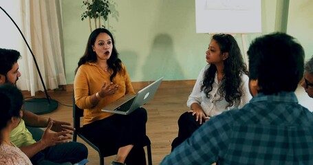 Indian Asian group in a business meeting, discussing mental health and support in a diverse office setting. Team communication, collaboration, and wellness in a professional conference room