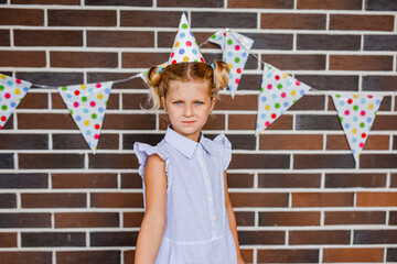 Cute preschooler girl makes art at a summer outdoor party