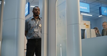 Security Checkpoint: Man with Bionic Prosthetic Leg Walking Through X-ray Metal Detector Scanner in...